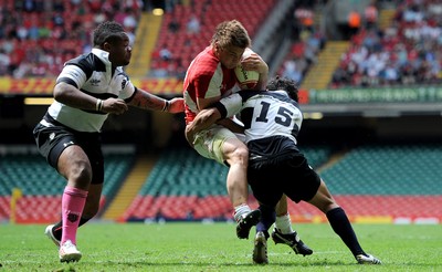 04.06.11 - Wales v Barbarians - DHL Challenge - Jonathan Davies of Wales is tackled by Mathieu Bastareaud and Isa Nacewa of Barbarians. 