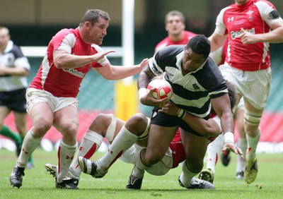 04.06.11 Wales v The Barbarians - DHL Challenge WRU 130th Anniversary Match - Barbarians' Iosefa Tekori is tackled by Wales' Toby faletau as Huw Bennett covers. 