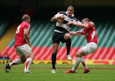 04.06.11 Wales v The Barbarians - DHL Challenge WRU 130th Anniversary Match - Barbarians' Willie Mason attempts to fend off Wales' Rhys Priestland as Paul James covers.  