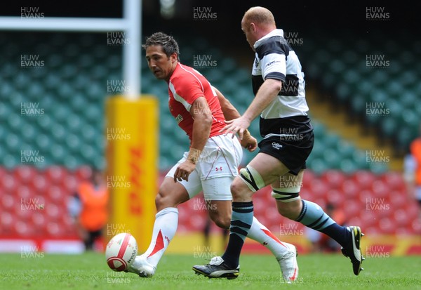 04.06.11 - Wales v Barbarians - DHL Challenge - Gavin Henson of Wales kicks the ball past Martyn Williams of Barbarians. 
