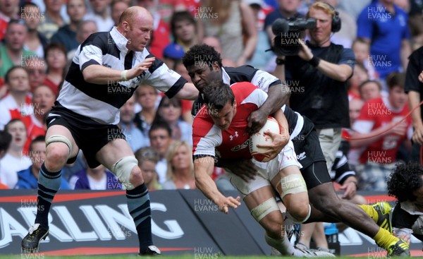 04.06.11 - Wales v Barbarians - DHL Challenge - Sam Warburton of Wales is tackled by Martyn Williams and Seru Rabeni of Barbarians. 