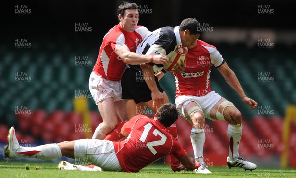 04.06.11 - Wales v Barbarians - DHL Challenge - Doug Howlett of Barbarians is tackled by Stephen Jones and Gavin Henson. 