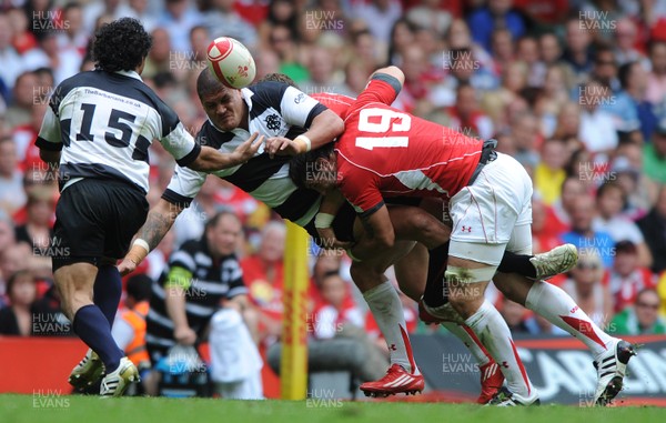 04.06.11 - Wales v Barbarians - DHL Challenge - Willie Mason of Barbarians is tackled by George North and Josh Turnbull of Wales. 