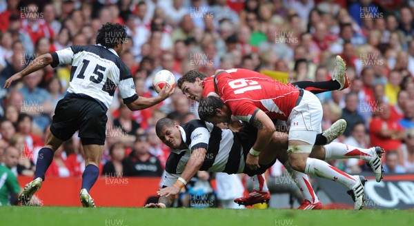 04.06.11 - Wales v Barbarians - DHL Challenge - Willie Mason of Barbarians is tackled by George North and Josh Turnbull of Wales. 