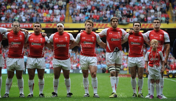 04.06.11 - Wales v Barbarians - DHL Challenge - Paul James, Huw Bennett, Ryan Bevington, Jonathan Davies, Ryan Jones, Stephen Jones and Sam Warburton of Wales line up for the national anthems with match mascot Thomas Hughes. 