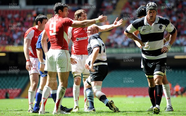 04.06.11 - Wales v Barbarians - DHL Challenge - Mike Phillips and Ryan Jones of Wales appeal to the linesman as Martyn Williams of Barbarians gets up from the ground. 