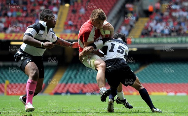 04.06.11 - Wales v Barbarians - DHL Challenge - Jonathan Davies of Wales is tackled by Mathieu Bastareaud and Isa Nacewa of Barbarians. 