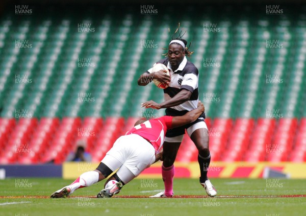 04.06.11 Wales v The Barbarians - DHL Challenge WRU 130th Anniversary Match - Barbarians' Paul Sackey is tackled by Wales' Aled Brew.  