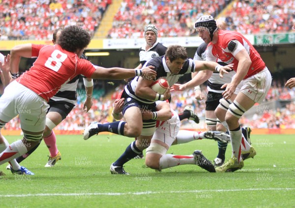 04.06.11 Wales v The Barbarians - DHL Challenge WRU 130th Anniversary Match - Barbarians' Sebastien Tillous-Borde is tackled by Wales' Morgan Sttodard as Toby Faletau(8) covers. 