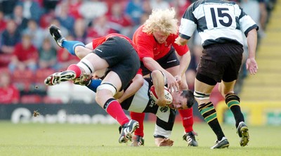 26-05-04. Wales v Barbarians. ASHTON GATE BRISTOL.  Barbarians' Matt Burke is up-ended by Michael Owen (left) and Duncan Jones (rt).  