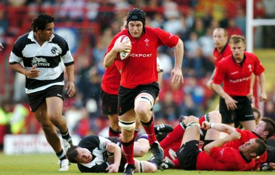 26-05-04. Wales v Barbarians. ASHTON GATE BRISTOL.  Wales' Michael Owen beats tackle to get away.  