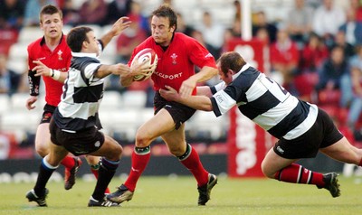 26-05-04. Wales v Barbarians. ASHTON GATE BRISTOL.  Wales' Rhys Williams is caught by Neil De Kock (left) and Matthew Sexton (rt)  