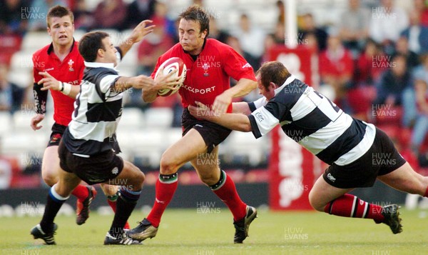 26-05-04. Wales v Barbarians. ASHTON GATE BRISTOL.  Wales' Rhys Williams is caught by Neil De Kock (left) and Matthew Sexton (rt)  