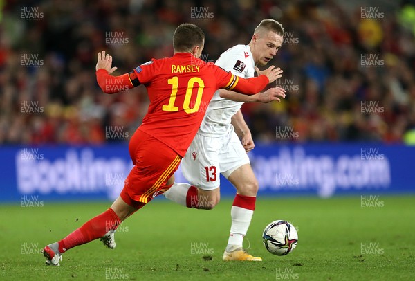 131121 - Wales v Belarus, 2022 World Cup Qualifying Match -  Nikolai Zolotov of Belarus is tackled by Aaron Ramsey of Wales
