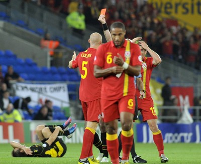 070912 - Wales v Belgium - FIFA 2014 World Cup Qualifying Match -   Wales' James Collins is show a red card by referee Stefan Johannesson