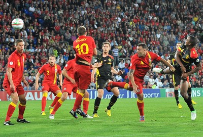 070912 - Wales v Belgium - FIFA 2014 World Cup Qualifying Match -   Belgiums' Vincent Kompany scores past the challenge of Wales' Darcy Blake 