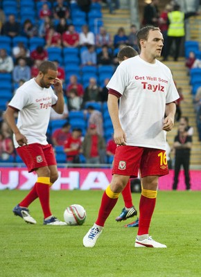 070912 - Wales v Belgium - FIFA 2014 World Cup Qualifying Match -    Wales substitutes warm t-shirts with tributes to injured team mate Neil Taylor as they warm up 