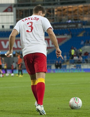 070912 - Wales v Belgium - FIFA 2014 World Cup Qualifying Match -    Wales substitutes warm t-shirts with tributes to injured team mate Neil Taylor as they warm up 