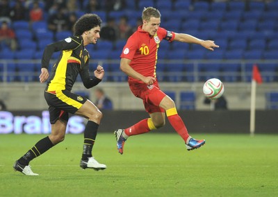 070912 - Wales v Belgium - FIFA 2014 World Cup Qualifying Match -   Wales' Aaron Ramsey  beats Belgiums' Marouane Fellaini to the ball  