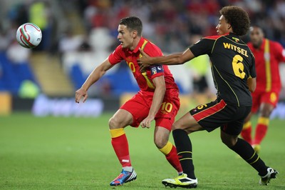070912 - Wales v Belgium, FIFA 2014 World Cup Qualifying match - Wales' Aaron Ramsey holds off Belgium's Axel Witsel 
