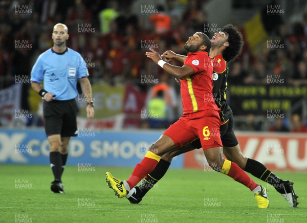 070912 - Wales v Belgium - FIFA 2014 World Cup Qualifying Match -   Wales' Ashley Williams and Belgiums' Marouane Fellaini in perfect synchrony as they battle for the ball 
