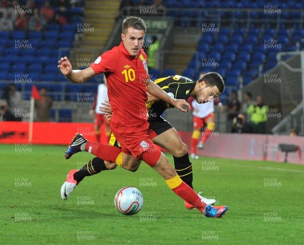 070912 - Wales v Belgium - FIFA 2014 World Cup Qualifying Match -  Wales' Aaron Ramsey, left, gets the better of Belgium's Eden Hazard