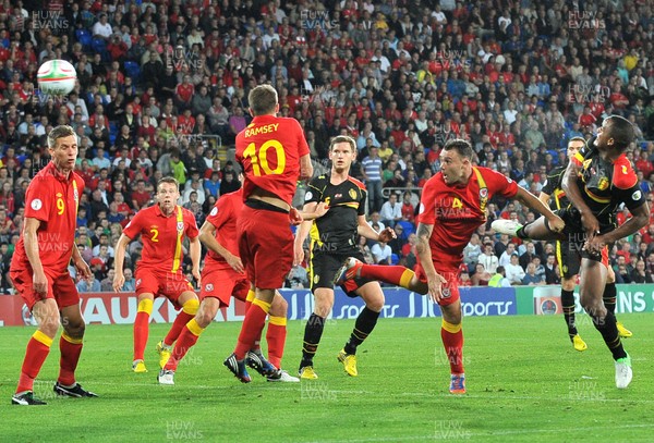 070912 - Wales v Belgium - FIFA 2014 World Cup Qualifying Match -   Belgiums' Vincent Kompany scores past the challenge of Wales' Darcy Blake 