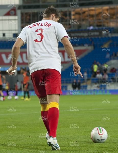 070912 - Wales v Belgium - FIFA 2014 World Cup Qualifying Match -    Wales substitutes warm t-shirts with tributes to injured team mate Neil Taylor as they warm up 