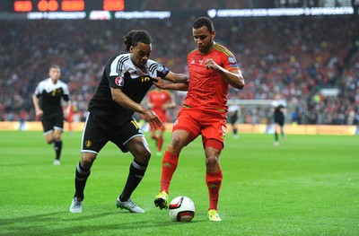 120615 - Wales v Belgium - UEFA European Championship 2016 Qualifier -Hal Robson-Kanu of Wales is challenged by Jason Denayer of Belgium