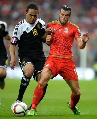 120615 - Wales v Belgium - UEFA European Championship 2016 Qualifier -Gareth Bale of Wales is challenged by Jason Denayer of Belgium