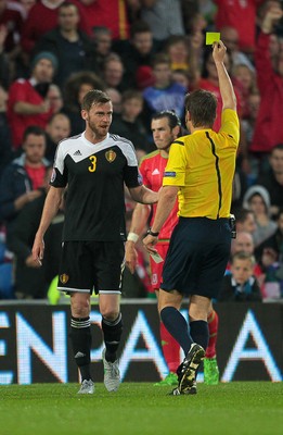 120615 - Wales v Belgium - UEFA European Qualifier - Nicolas Lombaerts of Belgium is shown a yellow card by Felix Brych
