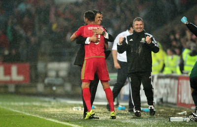 120615 - Wales v Belgium - UEFA European Qualifier - Wales manager Chris Coleman celebrates at full time with Hal Robson-Kanu of Wales