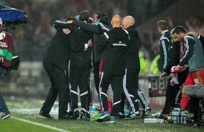 120615 - Wales v Belgium - UEFA European Qualifier - Wales manager Chris Coleman celebrates at full time with staff and Gareth Bale