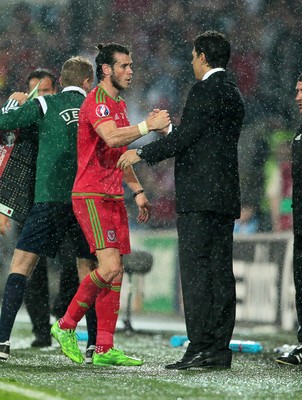 120615 - Wales v Belgium - UEFA European Qualifier - Gareth Bale of Wales shakes hands with Wales manager Chris Coleman as he goes off injured