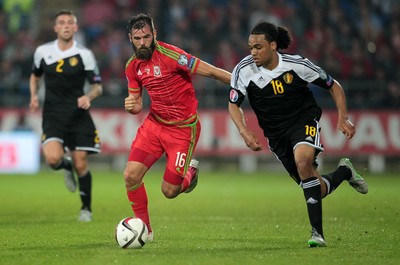 120615 - Wales v Belgium - UEFA European Qualifier - Joe Ledley of Wales challenges Jason Denayer of Belgium