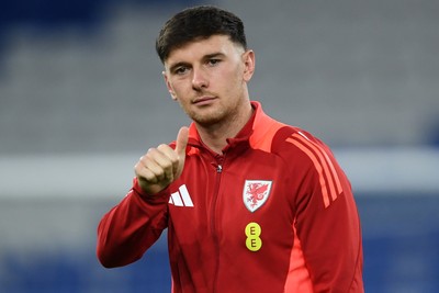 131025 - Wales v Belgium - 2026 FIFA World Cup Qualifying - Mark Harris of Wales arrives and inspects the pitch ahead of the match