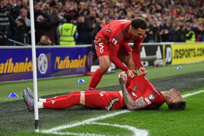 131025 - Wales v Belgium - 2026 FIFA World Cup Qualifying - Joe Rodon of Wales celebrates scoring a goal with team mates