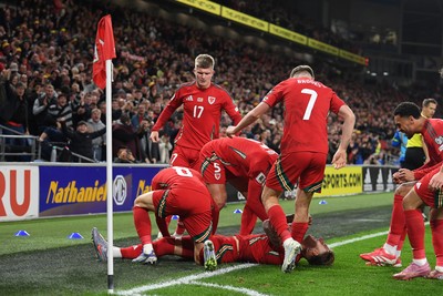 131025 - Wales v Belgium - 2026 FIFA World Cup Qualifying - Joe Rodon of Wales celebrates scoring a goal with team mates