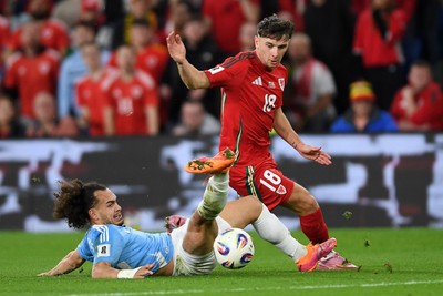 131025 - Wales v Belgium - 2026 FIFA World Cup Qualifying - Mark Harris of Wales is challenged by Arthur Theate of Belgium