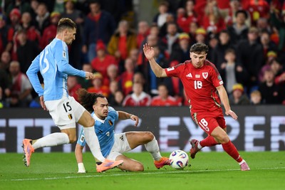 131025 - Wales v Belgium - 2026 FIFA World Cup Qualifying - Mark Harris of Wales is challenged by Arthur Theate of Belgium