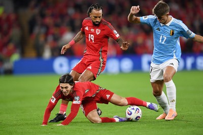 131025 - Wales v Belgium - 2026 FIFA World Cup Qualifying - Harry Wilson of Wales is challenged by Charles De Ketelaere of Belgium