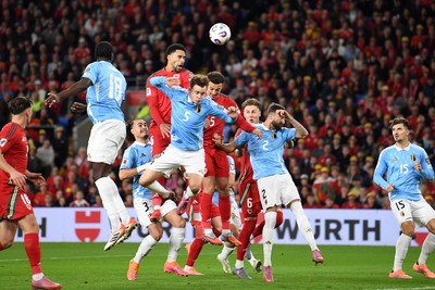 131025 - Wales v Belgium - 2026 FIFA World Cup Qualifying - Ben Cabango of Wales heads on goal