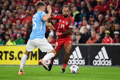 131025 - Wales v Belgium - 2026 FIFA World Cup Qualifying - Sorba Thomas of Wales is challenged by Thomas Meunier of Belgium