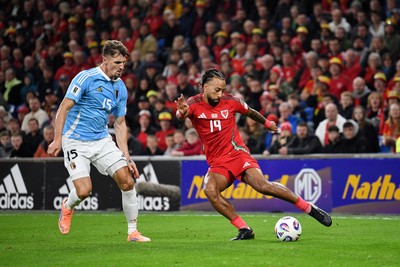 131025 - Wales v Belgium - 2026 FIFA World Cup Qualifying - Sorba Thomas of Wales is challenged by Thomas Meunier of Belgium