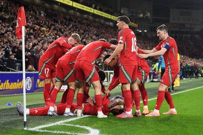 131025 - Wales v Belgium - 2026 FIFA World Cup Qualifying - Joe Rodon of Wales celebrates scoring the first goal of the game with team mates