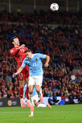 131025 - Wales v Belgium - 2026 FIFA World Cup Qualifying - Kieffer Moore of Wales is challenged by Timothy Castange of Belgium