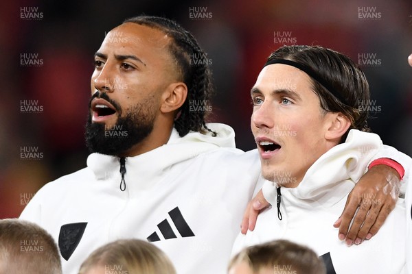 131025 - Wales v Belgium - 2026 FIFA World Cup Qualifying - Sorba Thomas and Harry Wilson of Wales during the anthem