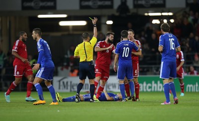 101014 - Wales v Bosnia-Herzegovina, UEFA European Championship 2016 - Referee tries to separate players as dis-agreement escalates