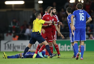 101014 - Wales v Bosnia-Herzegovina, UEFA European Championship 2016 - Referee tries to separate players as dis-agreement escalates