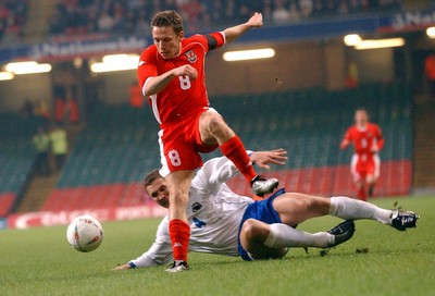 120203 - Wales v Bosnia-Herzegovina - International friendly - Wales' Craig Bellamy steps out of tackle by Muhamed Konjic